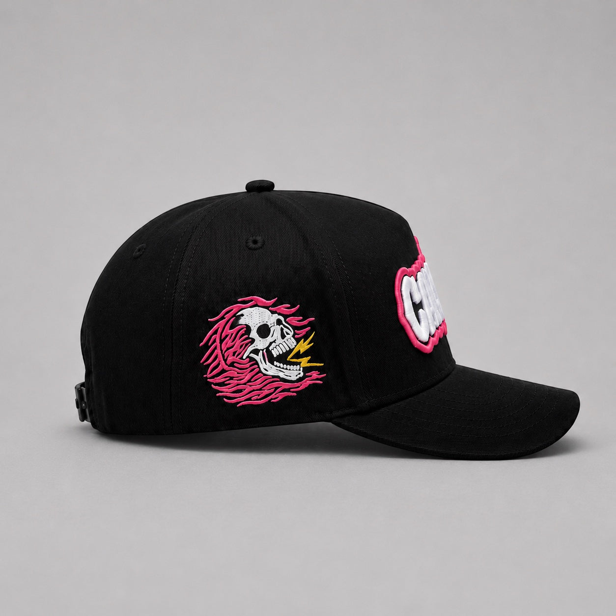 Black Capstify Skull Voltage A-Frame streetwear cap with premium embroidered flaming skull side patch, pink accents, yellow lightning detail, curved brim, and structured crown.