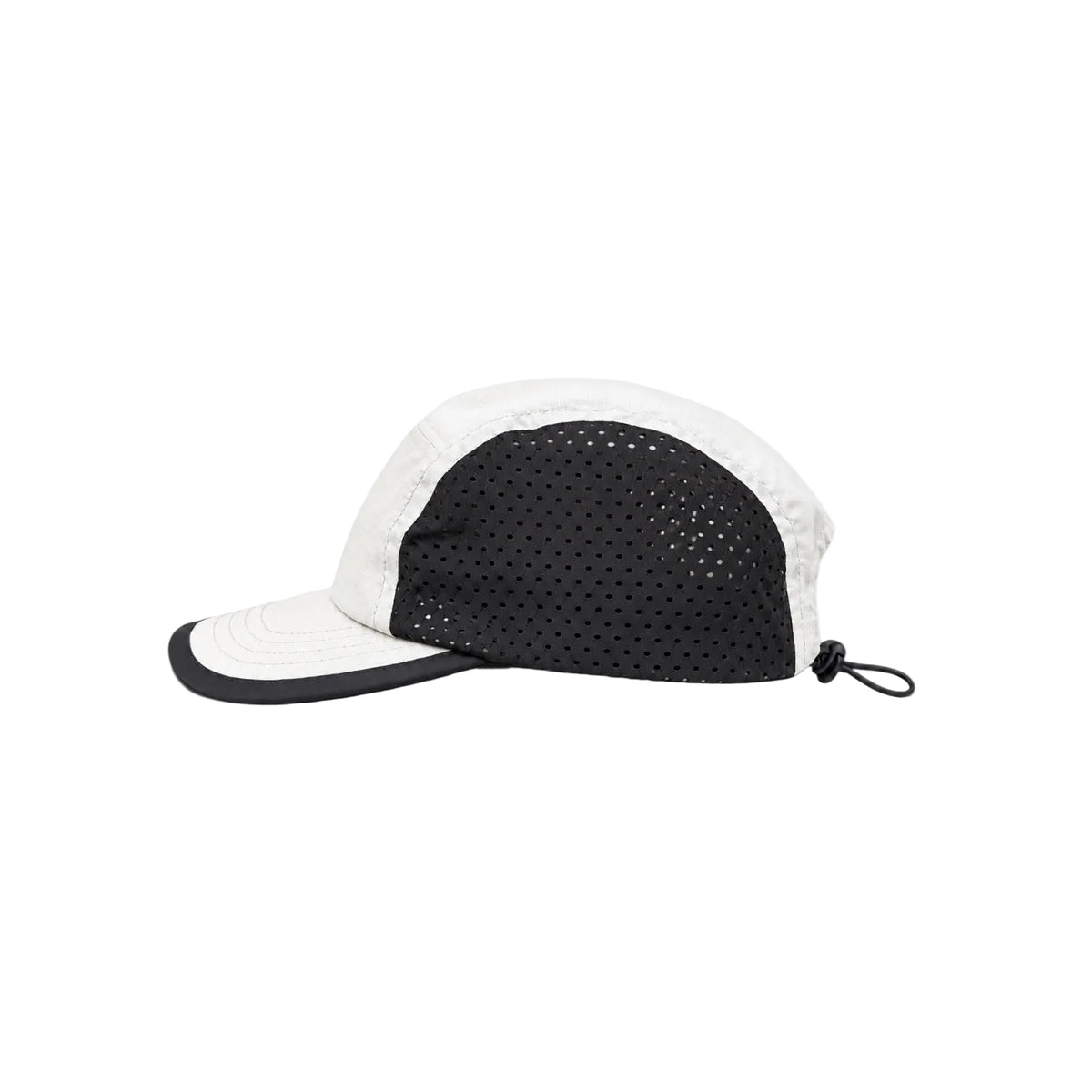 A black and white perforated cap with a curved brim, shown from a side profile on a solid white background.