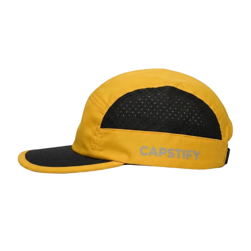 A yellow and black 5-panel running cap with a perforated back panel and a light gray CAPSTIFY logo on the side, shown against a plain white background.