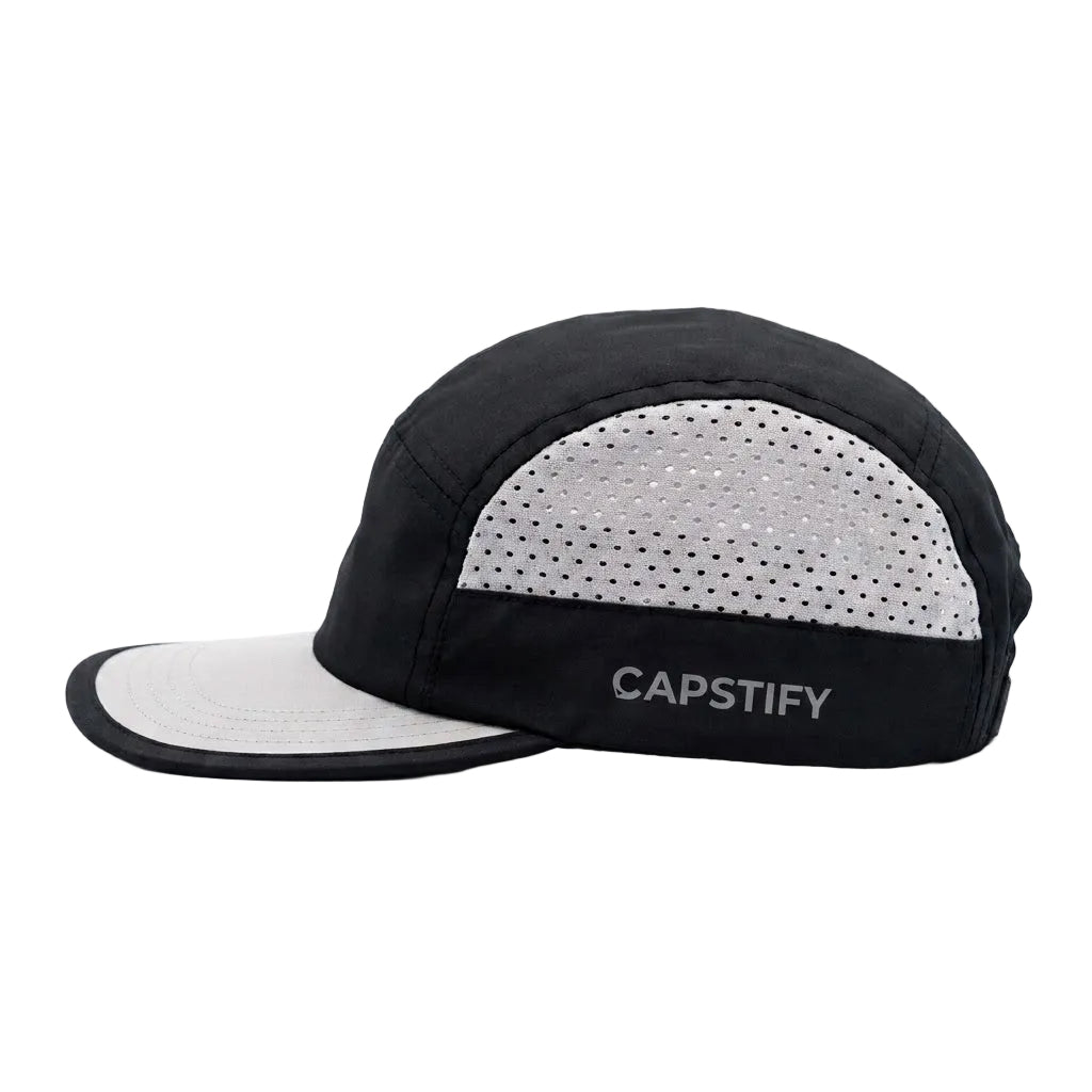 A black and light gray 5-panel running cap with a perforated back panel and the brand name 'CAPSTIFY' printed on the side, shown against a plain white background.